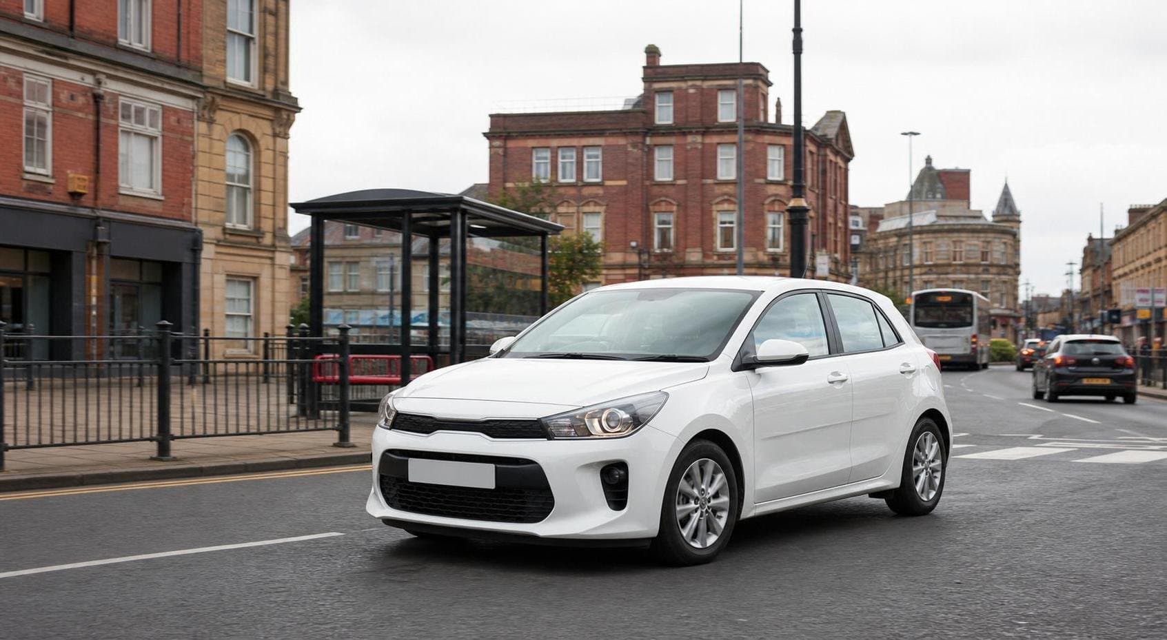 Compact hire car travelling through a market-town street in Clitheroe